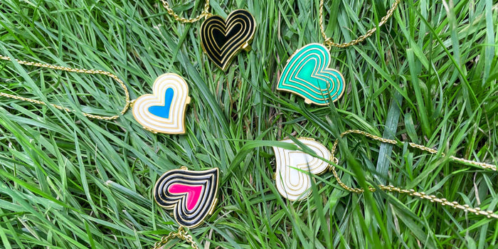 Five Deco Heart Lockets on top of grass.